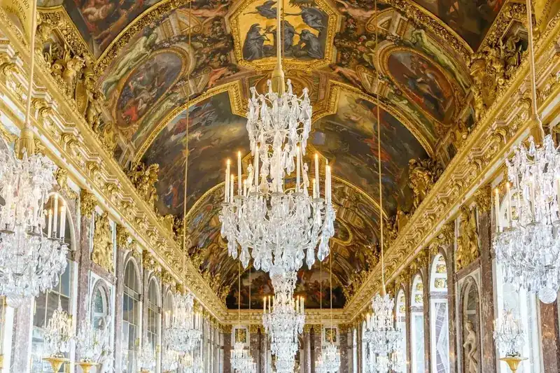 Hall of Mirrors at Versailles — crystal chandeliers, gilded ceiling frescoes and arched mirrors